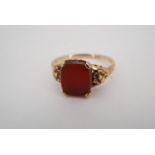 A carnelian signet ring, the cushion shaped vacant matrix claw set on a 9 ct yellow metal shank