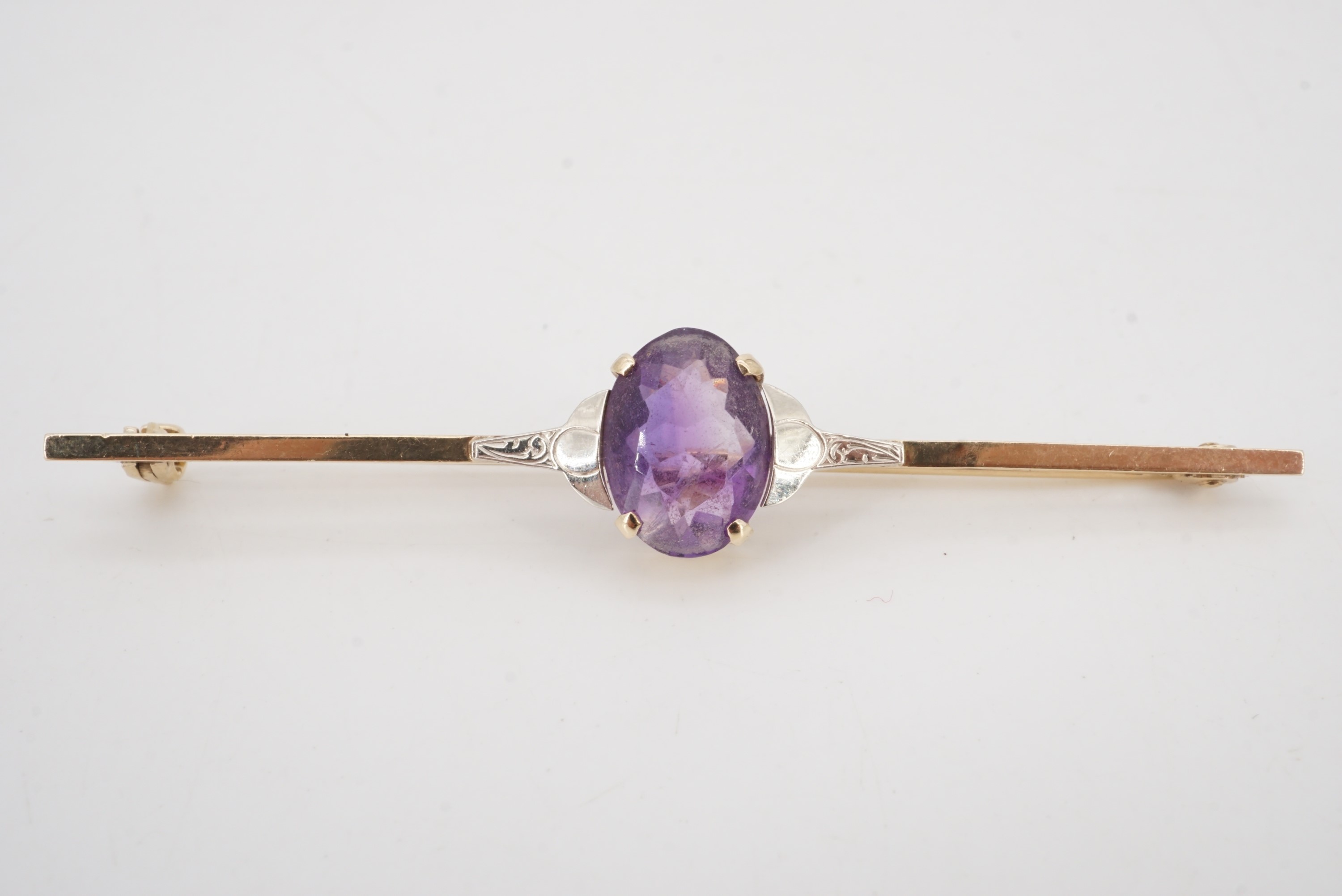 An amethyst and 9 ct gold bar brooch, circa 1930s, stone 11 mm x 8 mm, 6 cm, 3.8 g