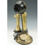 A reproduction rotary dial candlestick telephone