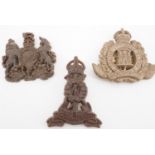 A Second World War Suffolk Regiment plastic cap badge together with two other plastic badges (latter