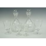 A pair of decanters together with six medium wine glasses, six sherry glasses etc