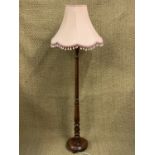 A turned wooden standard lamp