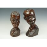 A pair of African carved busts, tallest 32 cm
