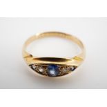 A 1940s sapphire and diamond ring, comprising a central oval sapphire of approximately 3 x 4 mm