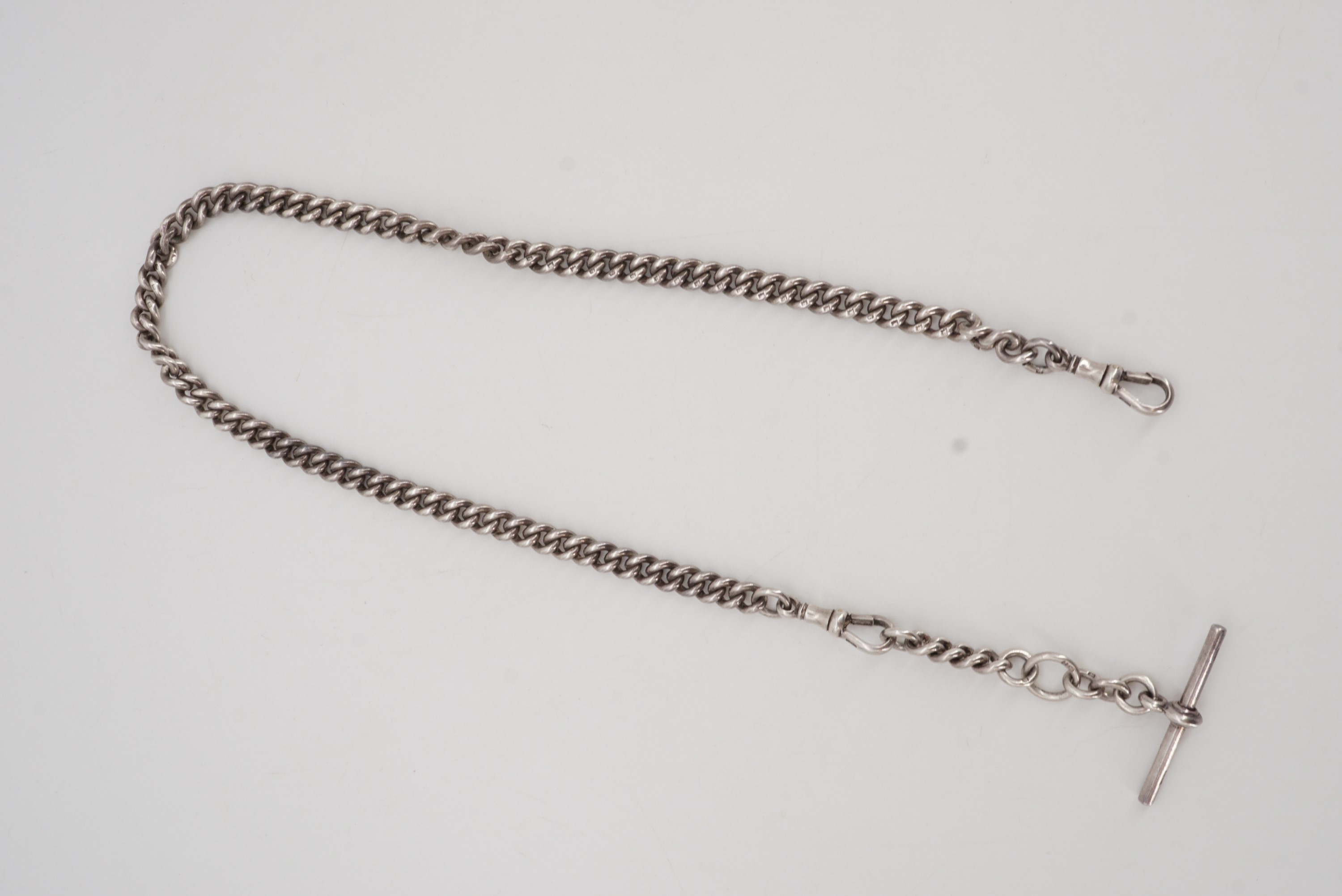 A Victorian silver curb link watch chain, with T-bar and swivels, 40 cm, 53 g