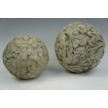 A pair of large painted terracotta relief-moulded spherical garden or domestic ornaments, largest 25