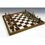 A resin medieval figural style chess set (kings 10 cm) with board