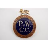 An early 20th Century King's Own Royal Lancaster Regiment "P of W C C" enamelled lapel badge