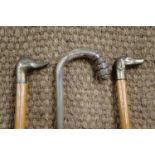 Three walking canes including dog and duck pommels