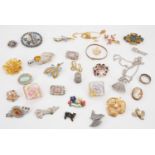 A quantity of vintage costume jewellery brooches and a silver thimble