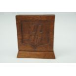 A wooden desk ornament bearing carved SS runes and the divisional symbol of the 1st SS Panzer