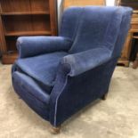 A late 19th / early 20th Century upholstered lounge armchair