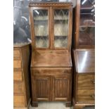 A George VI leaded-glazed oak bureau bookcase, of diminutive stature, 74 cm x 185 cm