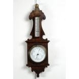 A carved oak aneroid barometer, 58 cm high
