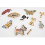 A quantity of vintage costume jewellery brooches including a kitsch plastic two-piece combination of