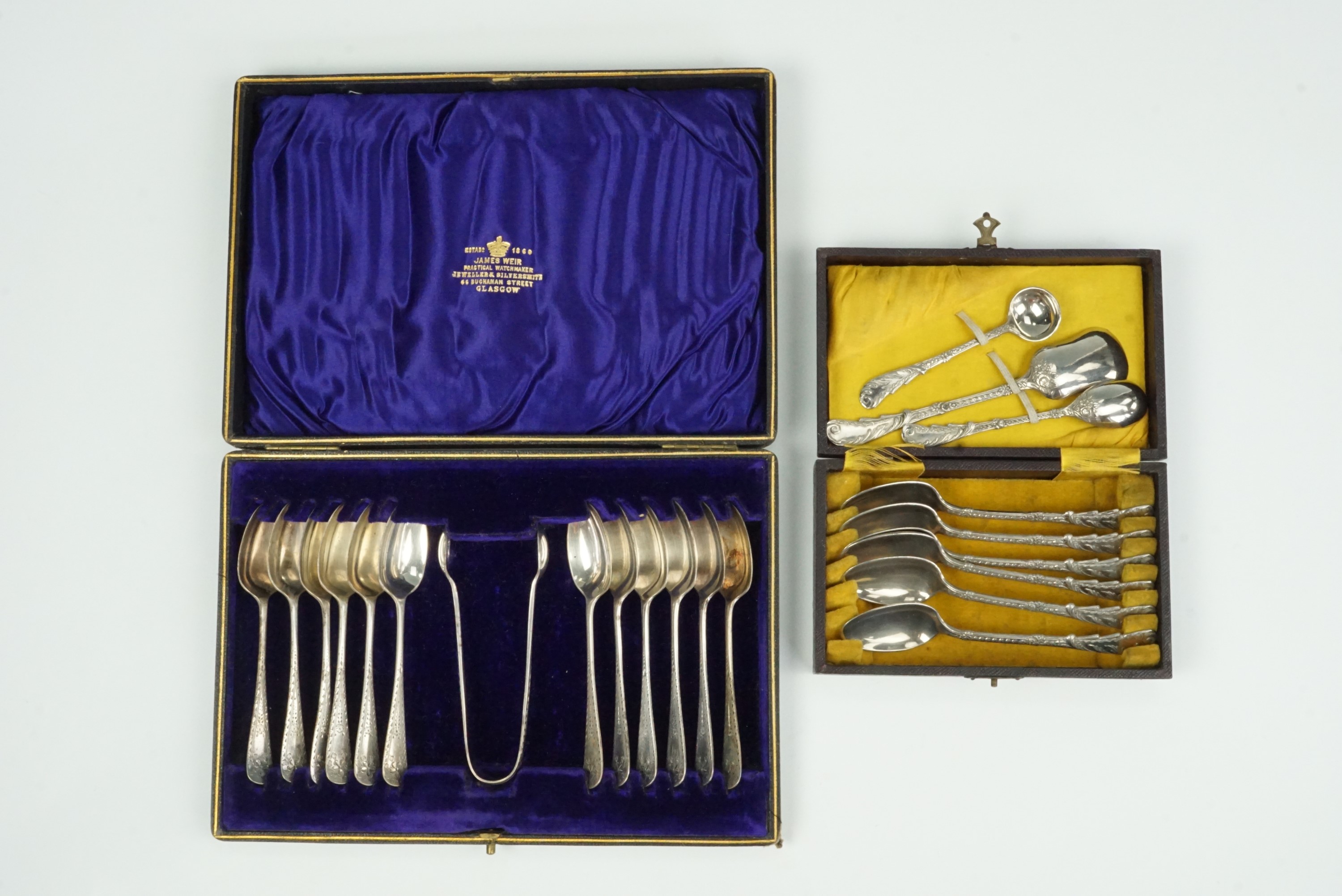 A cased set of twelve electroplate teaspoons and sugar tongs, together with cased teaspoons