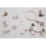 A group of silver and white metal (tested as silver) jewellery including a charm bracelet, bangle,