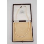 A single strand necklace of graded pearls, having marcasite and white metal clasp, cased, largest