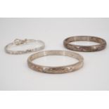 Two white metal hinged bangles, 25 g, together with a Mexican hinged "belt" bangle
