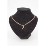 A 9 ct gold faceted curb link neck chain with yellow metal "horn of plenty" pendant, 52 cm, 4.9 g