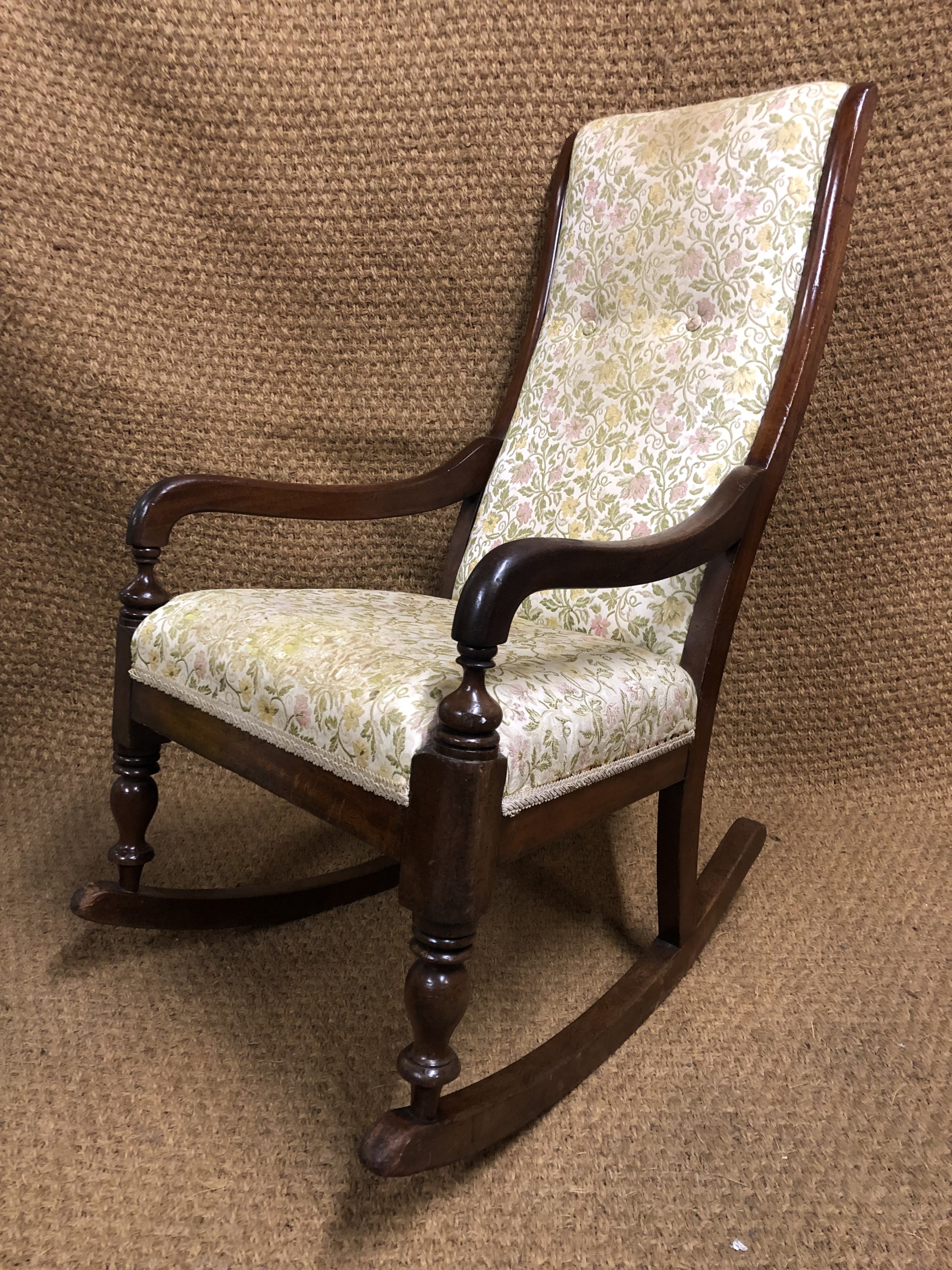 A Victorian upholstered mahogany rocking chair