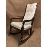 A Victorian upholstered mahogany rocking chair