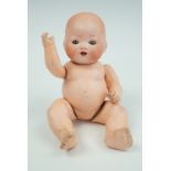 A late 19th / early 20th Century Armande Marseilles bisque-headed baby doll, of diminutive