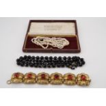 A vintage triple strand necklace of graded pearls, having a marcasite set clasp, largest pearls 5