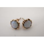A pair of opal and 9 ct gold stud earrings, set with 6 mm circular cabochons