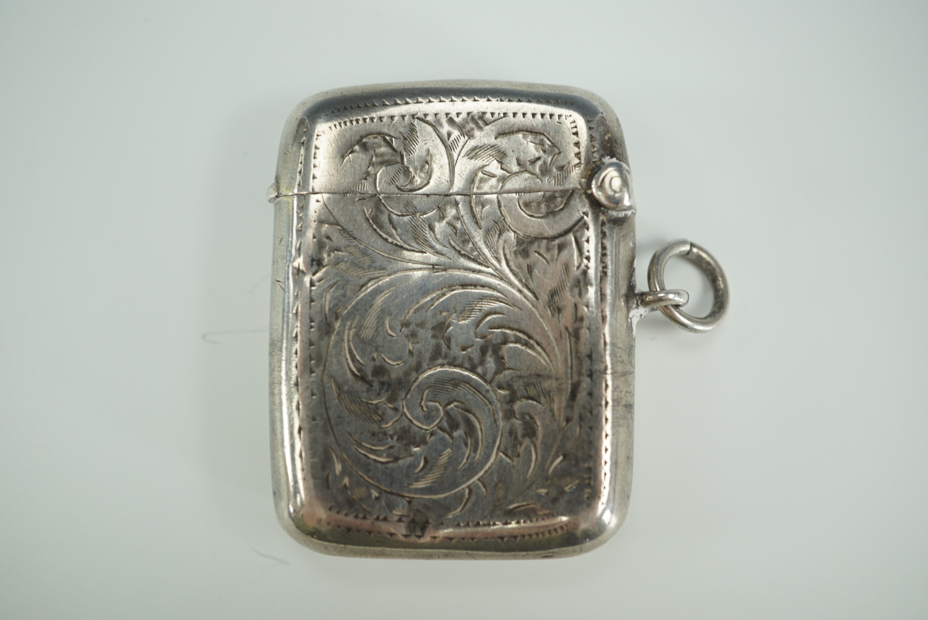 A George V silver Vesta case, contoured cushion shaped and foliate scroll engraved - Image 2 of 4