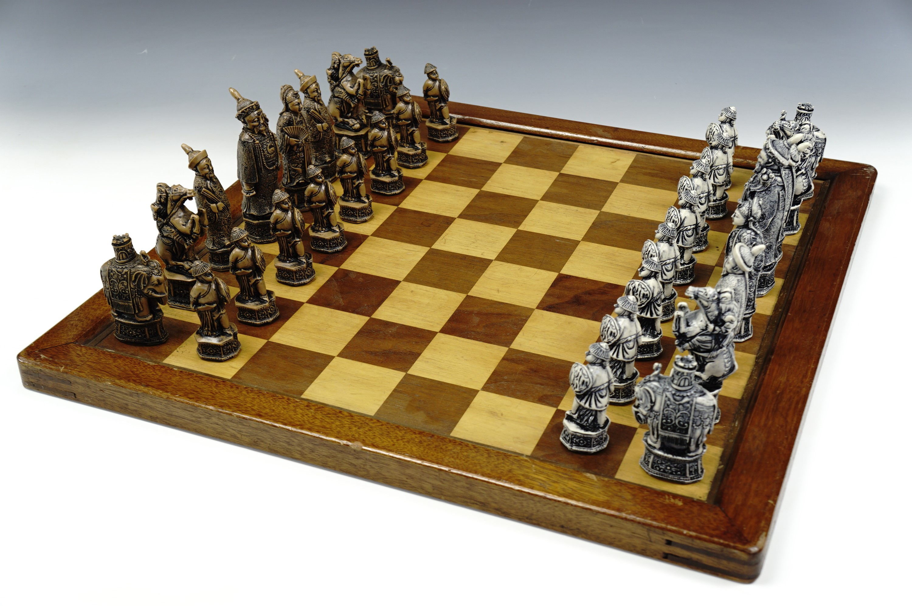 A resin Chinese figural chess set (king's 13 cm), with board