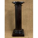 An ebonised fluted columnar jardiniere stand, 95 cm high