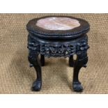 A late 19th / early 20th Century Chinese carved hardwood jardiniere stand, having a marble-inset