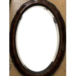 A Victorian oval walnut mirror, 88 cm x 62 cm