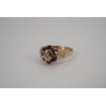 An almandine and diamond flowerhead cluster ring, the stones claw set on a tapering 9 ct gold