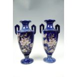 A pair of Victorian two-handled vases decorated with raised gilding an a naturalistic floral