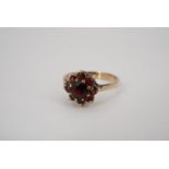 A garnet and 9 ct gold flowerhead cluster ring, N/O, 2.4 g