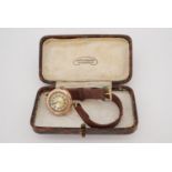 A 1920s lady's Record 9 ct gold wristlet watch, having a parcel-gilt circular face with Arabic