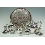 A three piece electroplate tea set together with a circular tray and pair of Viner's candlesticks
