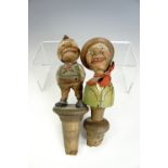 A pair of Anri style novelty carved and painted wooden mechanical bottle stoppers, Italy, second