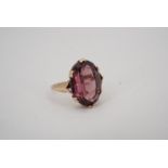 An amethyst coloured paste and yellow metal cocktail ring, K, 2.3 g