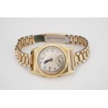 A 1930s Centaur 18ct gold wristwatch having a tonneau shaped case on a rolled gold bracelet strap,