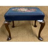 A George III walnut stool, having and overstuffed upholstered seat and cabriole legs with slipper