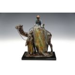 A cold-painted spelter novelty figural cigarette lighter modelled as a North African selling a rug