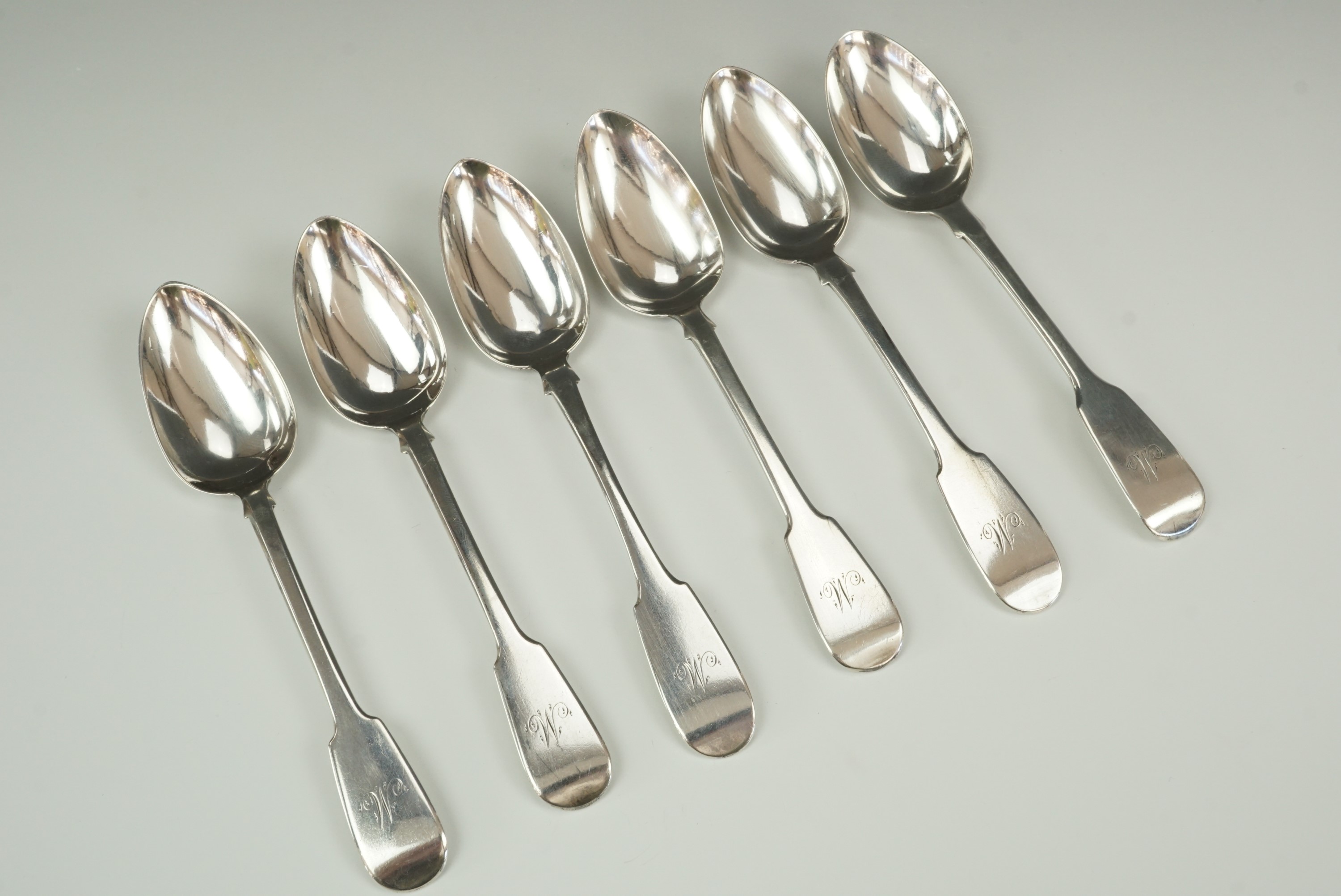 Five Georgian silver fiddle pattern tea spoons, Thomas Wheatley, Newcastle, 1836, with one other