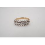 A 9 ct gold and paste ring, comprising three rows of claw-set brilliants on a subtly tapering shank,