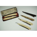 A cased pair of Ivorine handled cutthroat razors and four other razors