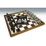 A resin Lewis chess set (kings 8.5 cm) together with a board and book
