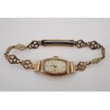 A 1940s Avia lady's 9 ct gold wristlet watch, having a tonneau shaped case and rolled gold