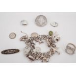 A silver charm bracelet, Victorian coin brooch, locket, "Mother" brooch and coin ring, 89 g